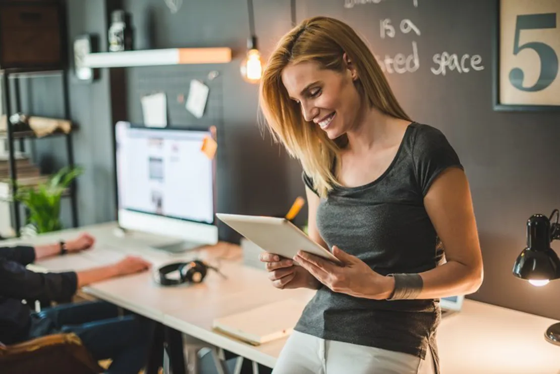 Woman reading from an ipad in an office