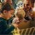 Woman with two young boys opening a box