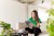 A woman in a green top completing a soft search finance application on her tablet