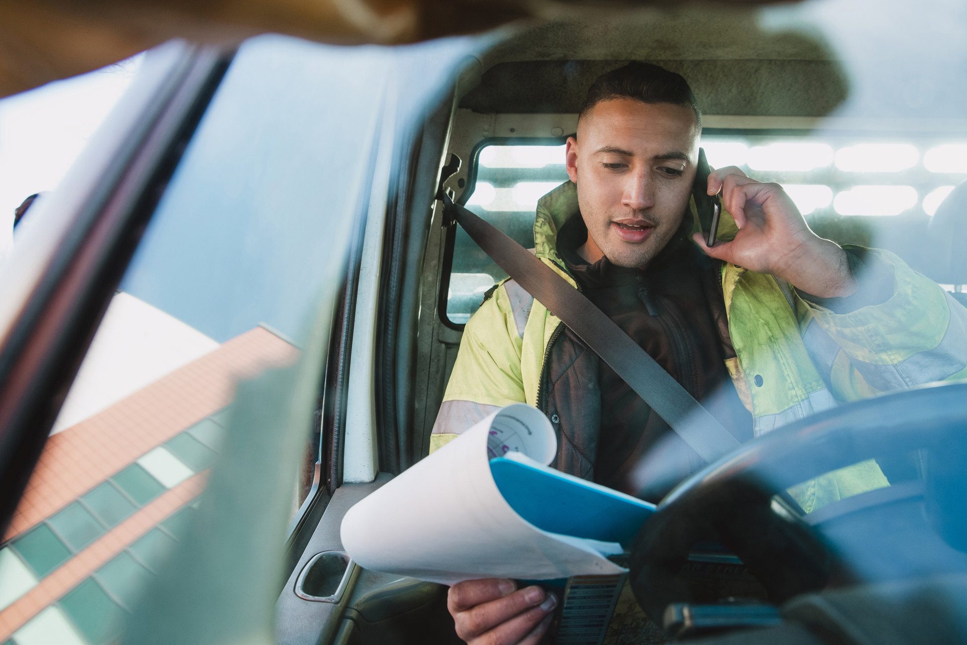 Manual Worker on Mobile Phone in His Van