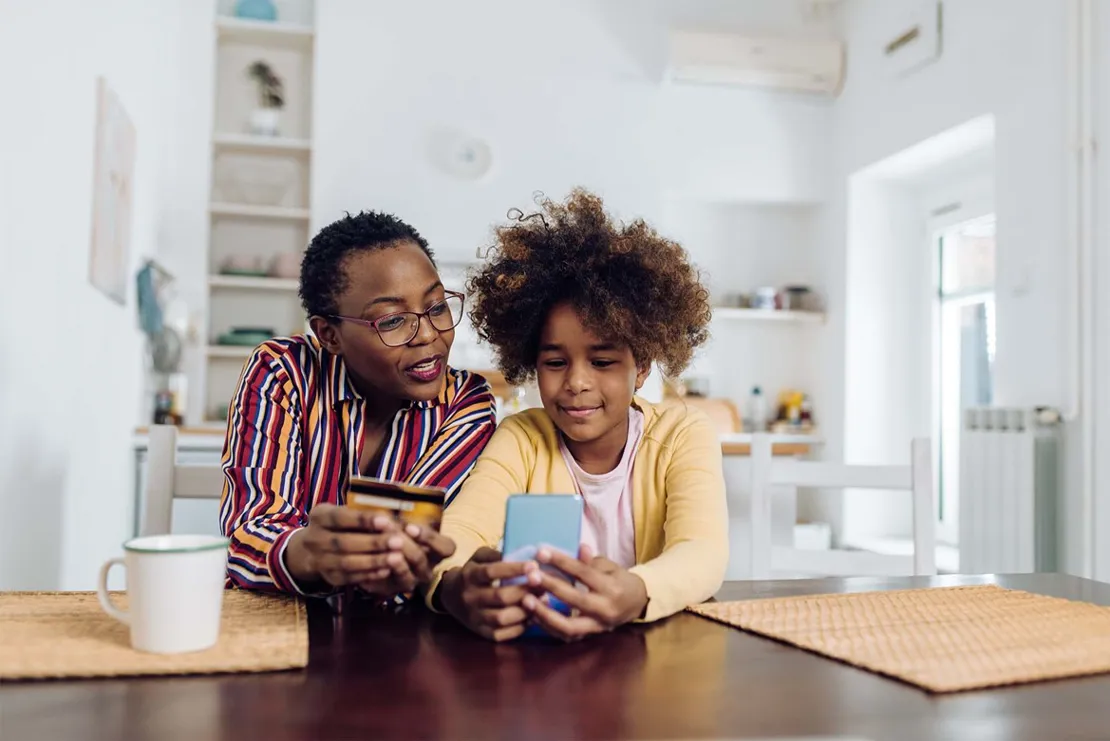 Woman and child making online payment with credit card