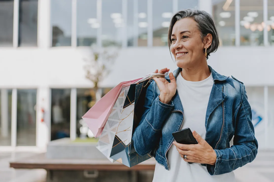 Woman Carrying a Shopping Bag Outside of Retail Store