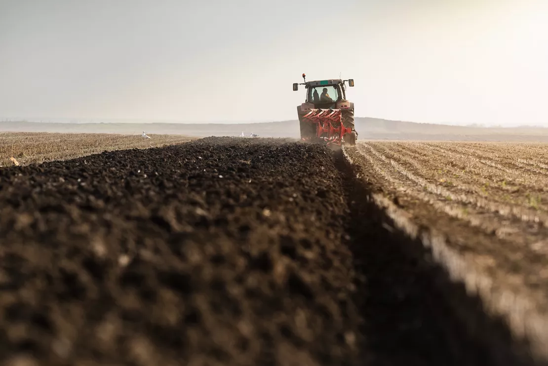 Tractor planting seeds in a field