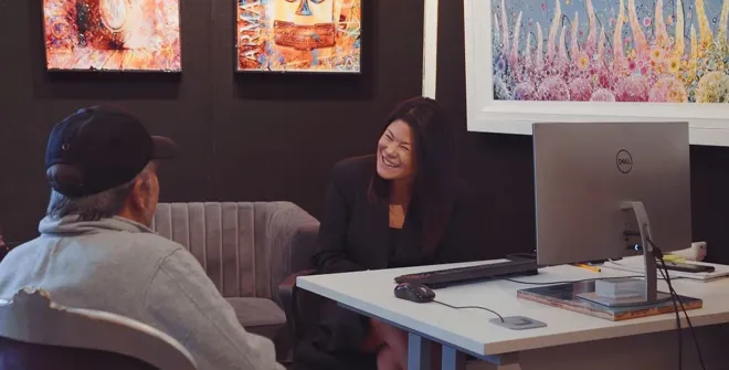 Art gallery sales consultant working helping a customer