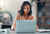 Young woman typing on a laptop while filling out an application