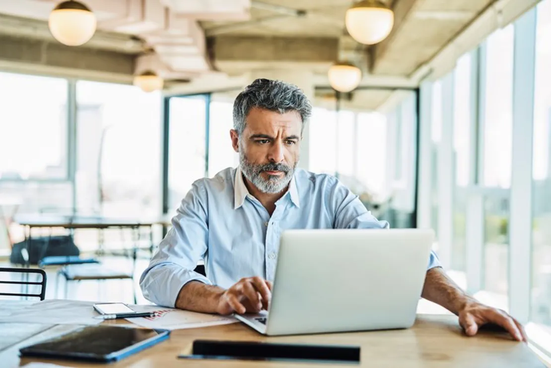 Businessman Using Laptop In Coworking Office