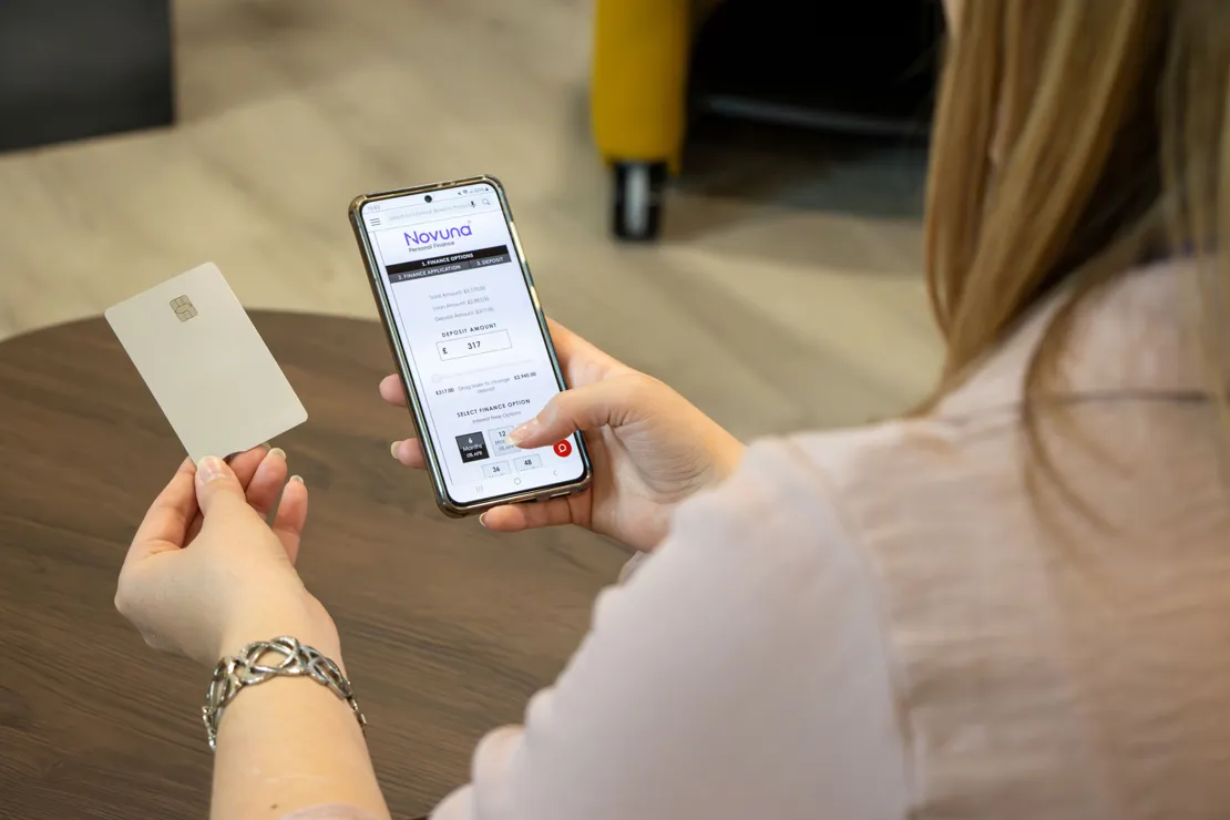 Woman looking at the Novuna finance calculator while online shopping