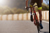 Close up of the wheels of a man riding a bike in the sunshine