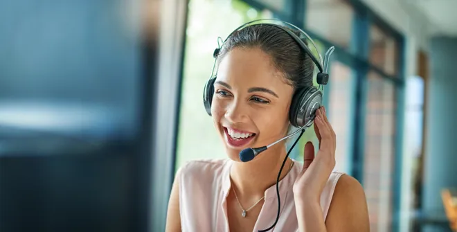 Customer experience expert speaking to a customer through her headset