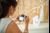 Woman taking a professional photo of jewellery on a display stand