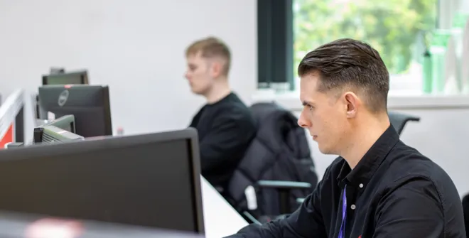 Senior Business Development Manager, Max Walker, working on a computer