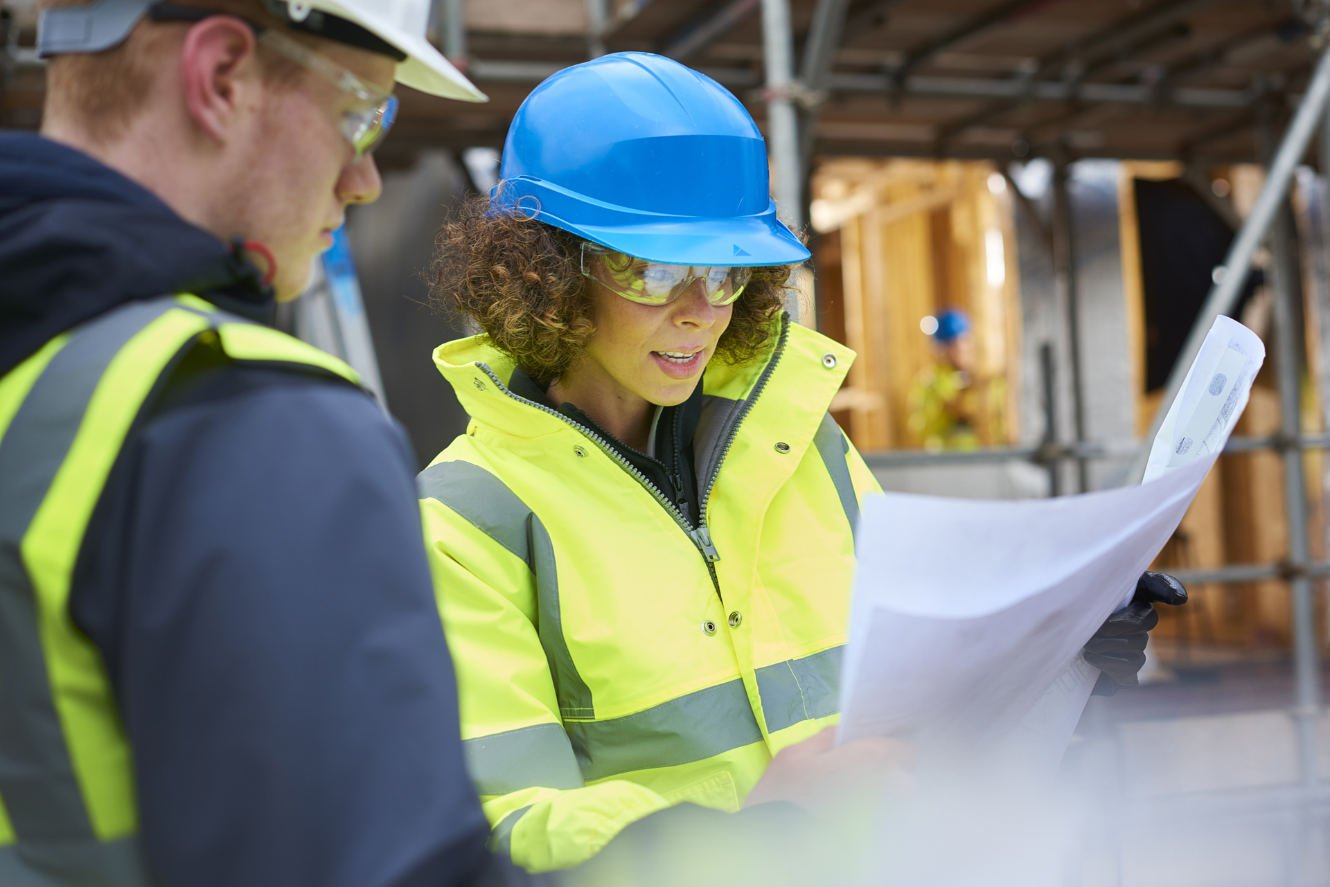 Female Construction Foreman Instructing A Worker 647760480