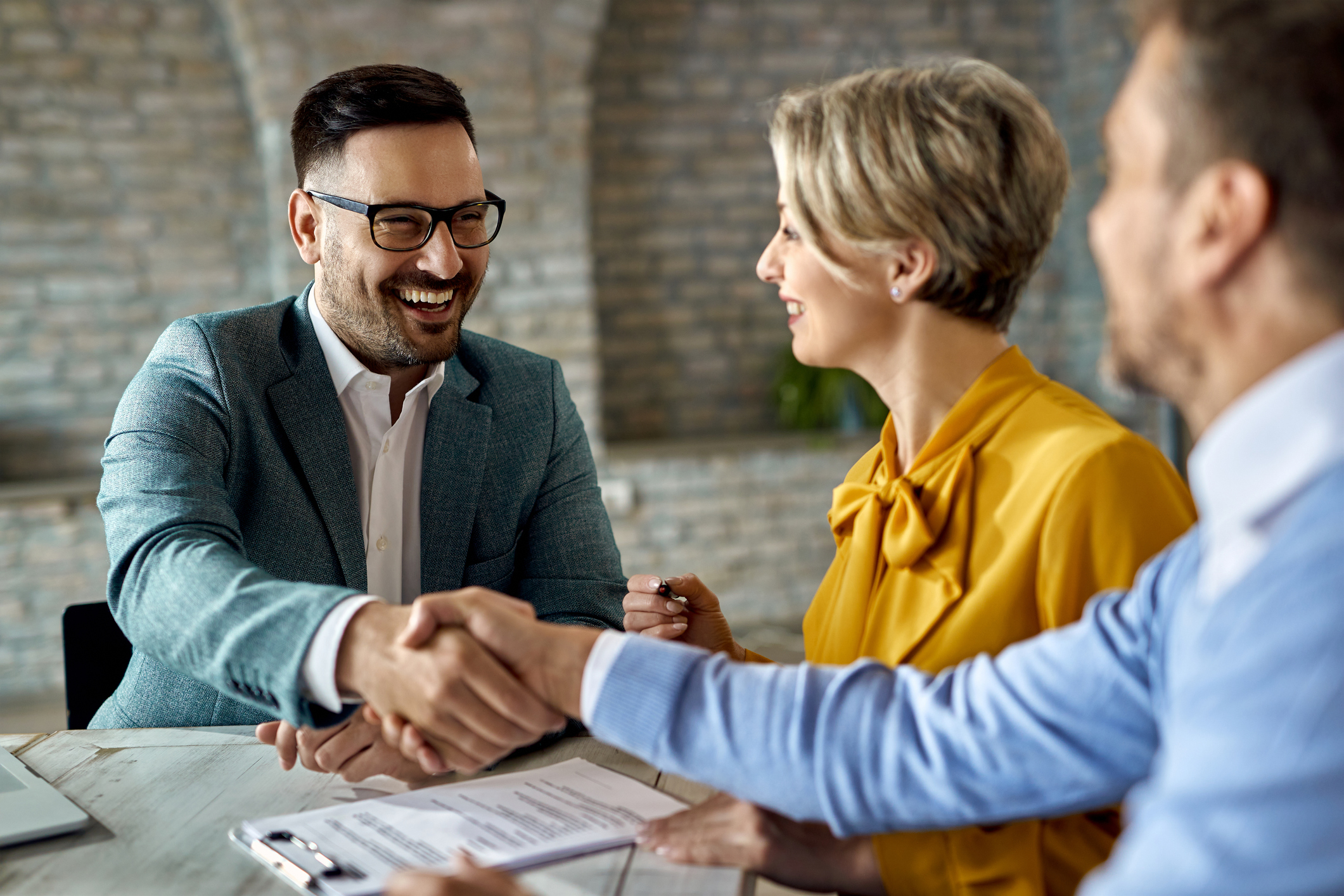 Businessperson talking to a couple about finance