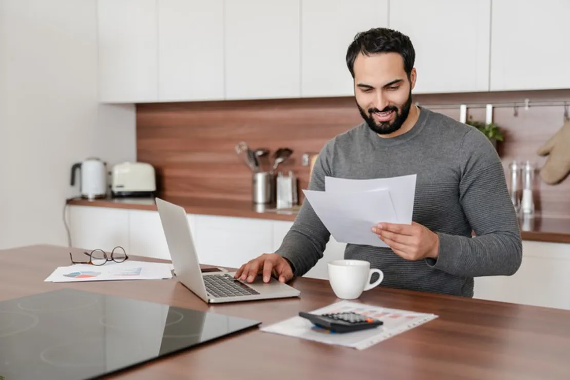 Male Accountant Working From Kitchen
