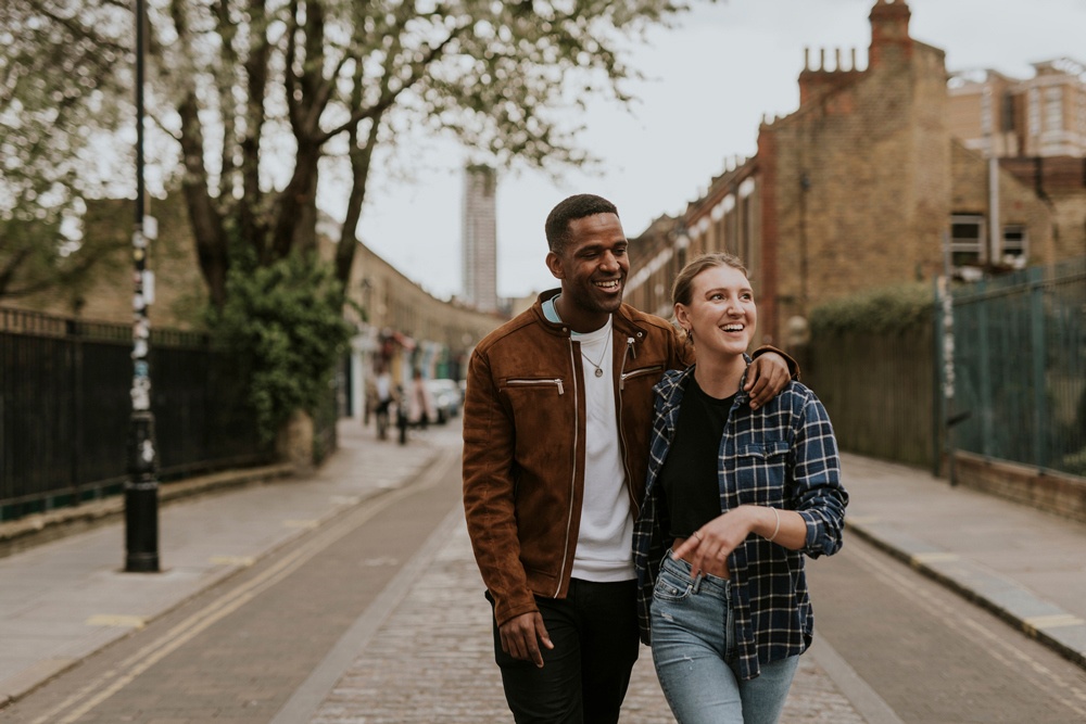 Diverse couple on a date, walking in the city